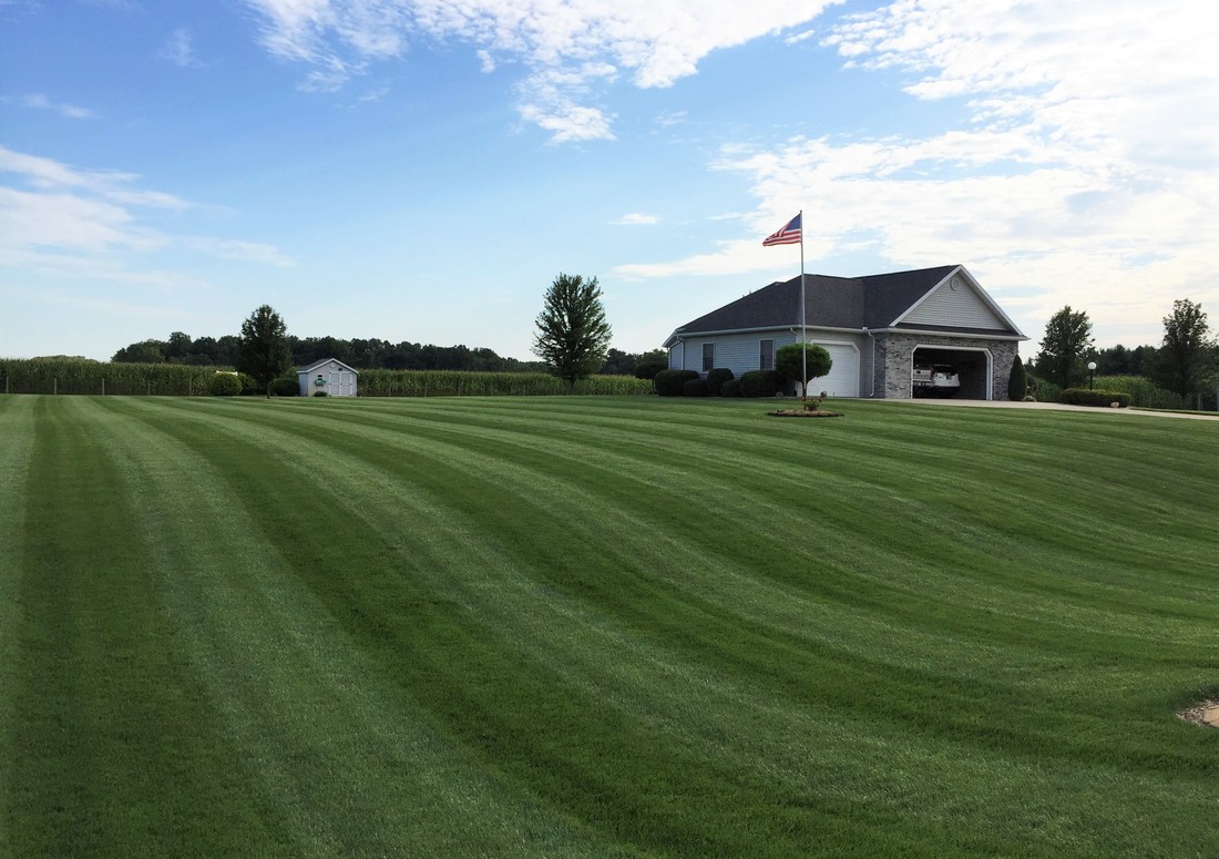 Wide striped lawn around a northeastern Indiana home